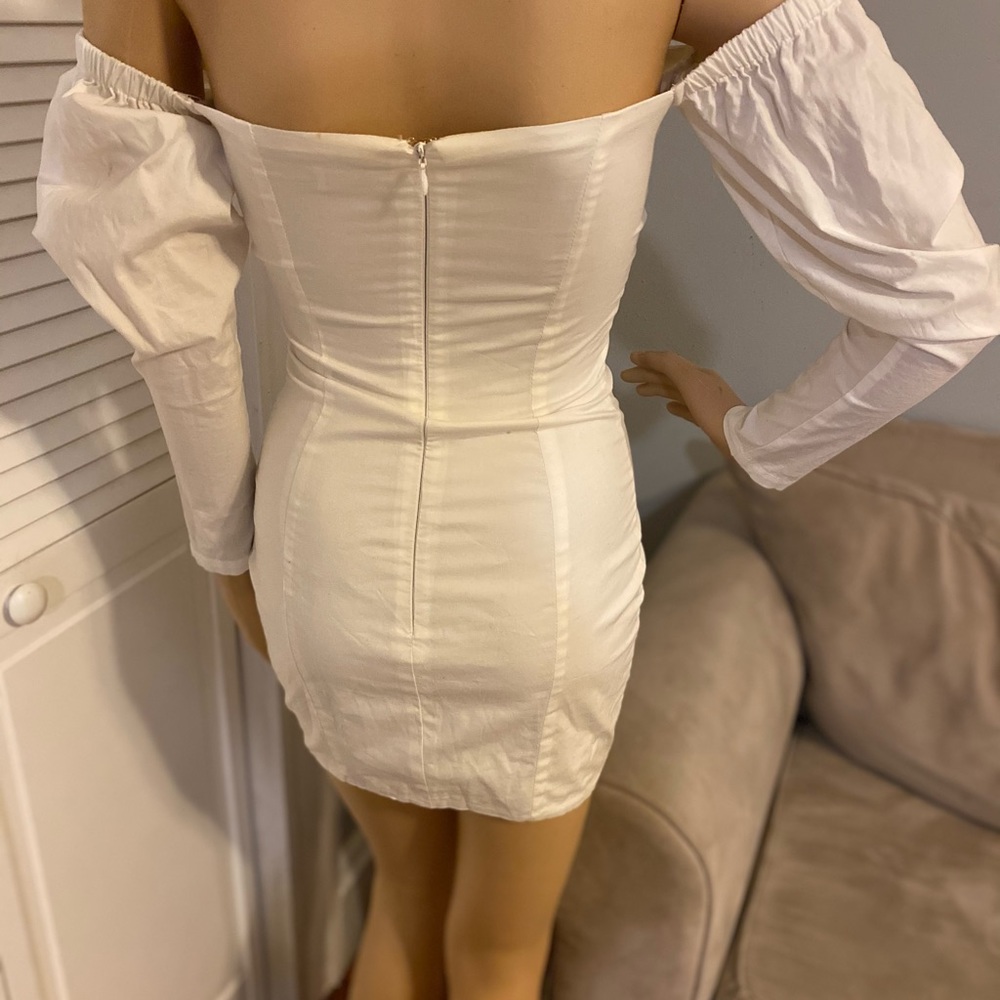 Cream off the shoulder mini dress .